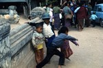 Children, northern Thailand or Laos; Don Blakemore, Stephen Krichels, and Brian Francis bartering for silk in background (ca. 1970)