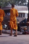  Monks walking past street vendors (Bangkok?) 