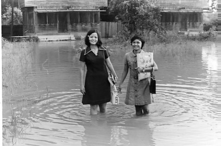 Two teachers heading off to work in the rainy season in Korat. Sakorn, Kevin's future wife, is on the right. June 72