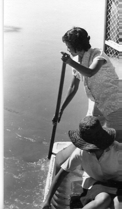 Sakorn, my future wife, paddling a "boat" made from styrofoam bomb casings. These were widely used in Thailand as boats.