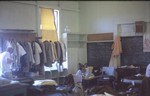 View of men's dorm at Pepeekeo. Steve Tripp on the bed and Thai words on the blackboard.